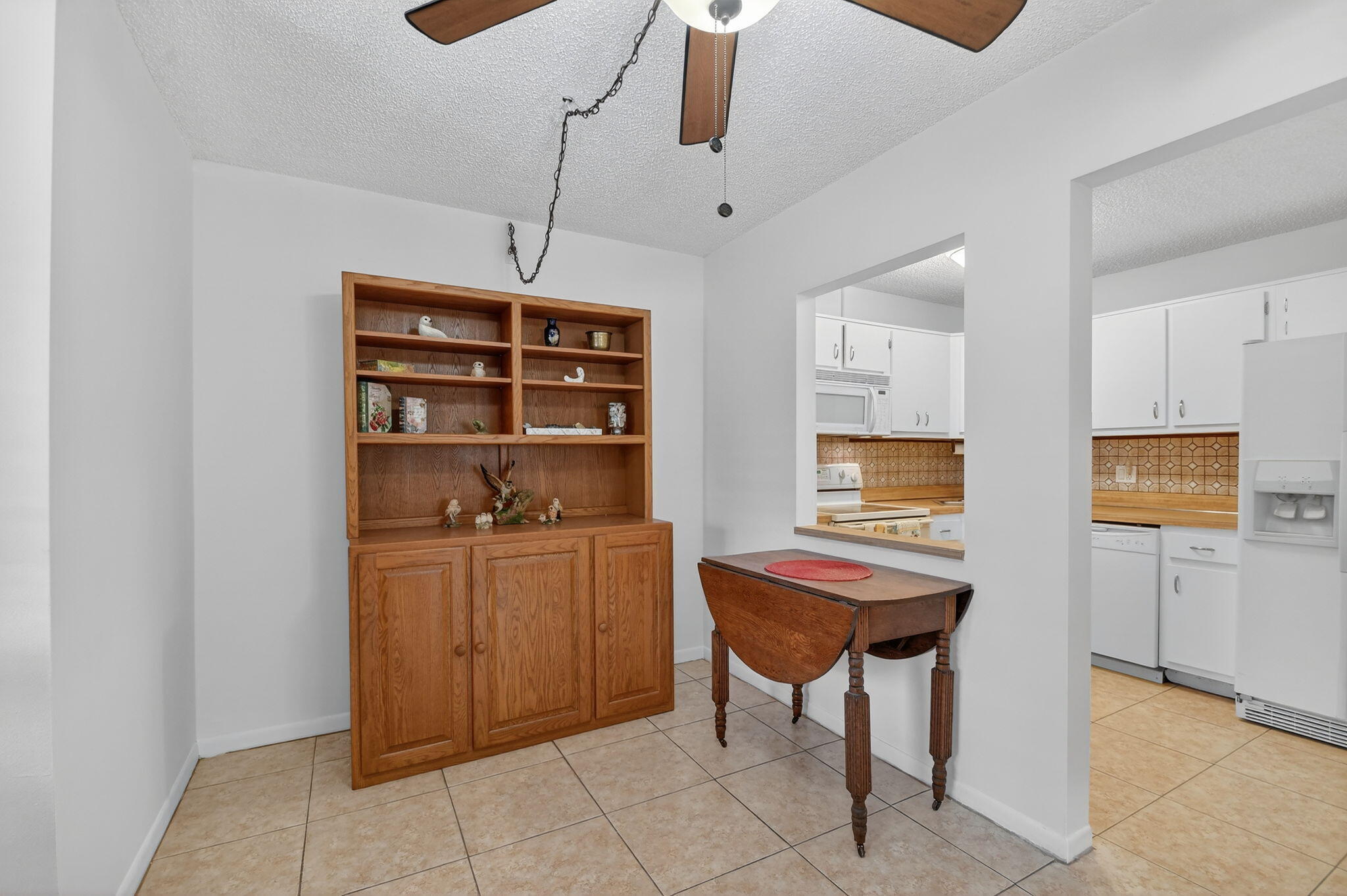 342 Pine Ridge Circle, Unit D1 Greenacres, FL 33463 - Photo 9 of 24 a room with furniture a rug and white walls