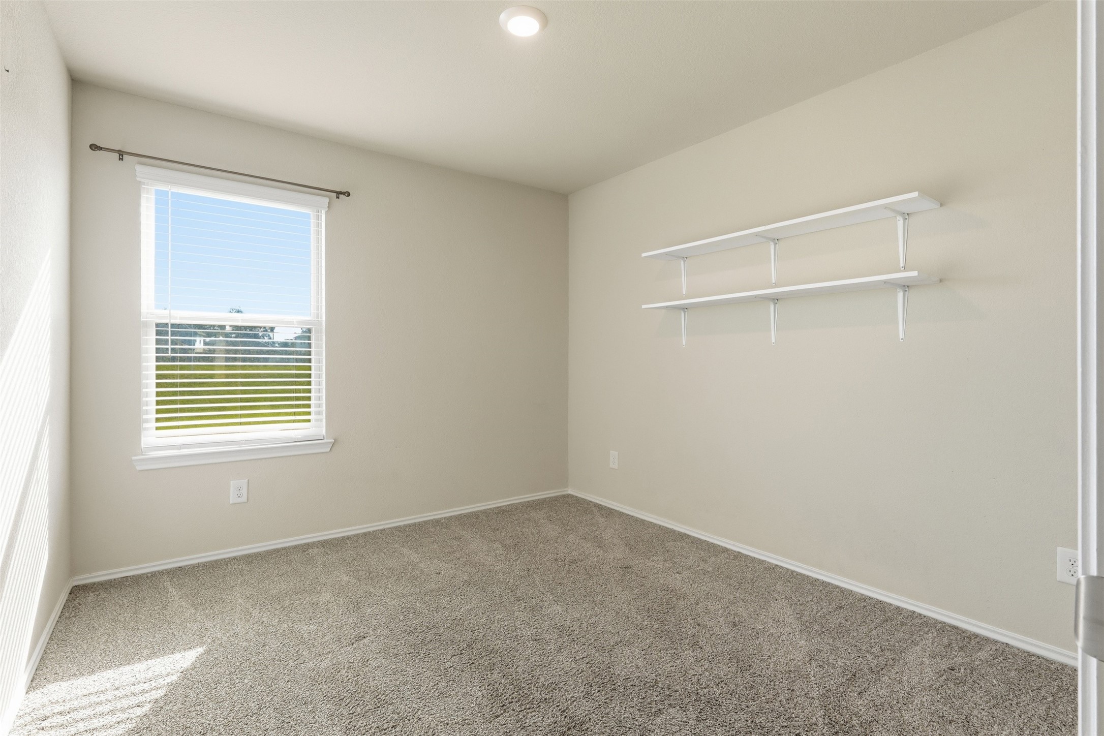 2346 Gold Forsythia Ln Spring Spring, TX 77373 - Photo 22 of 39 Cozy secondary bedroom with plush carpeting, ample natural light, and convenient built-in shelving.