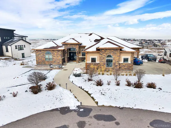 a view of residential houses with snow on the road
