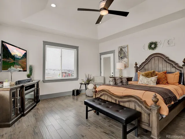 a bedroom with a bed and a chandelier