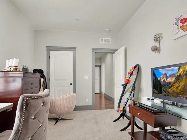 a bathroom with a granite countertop sink mirror vanity and toilet