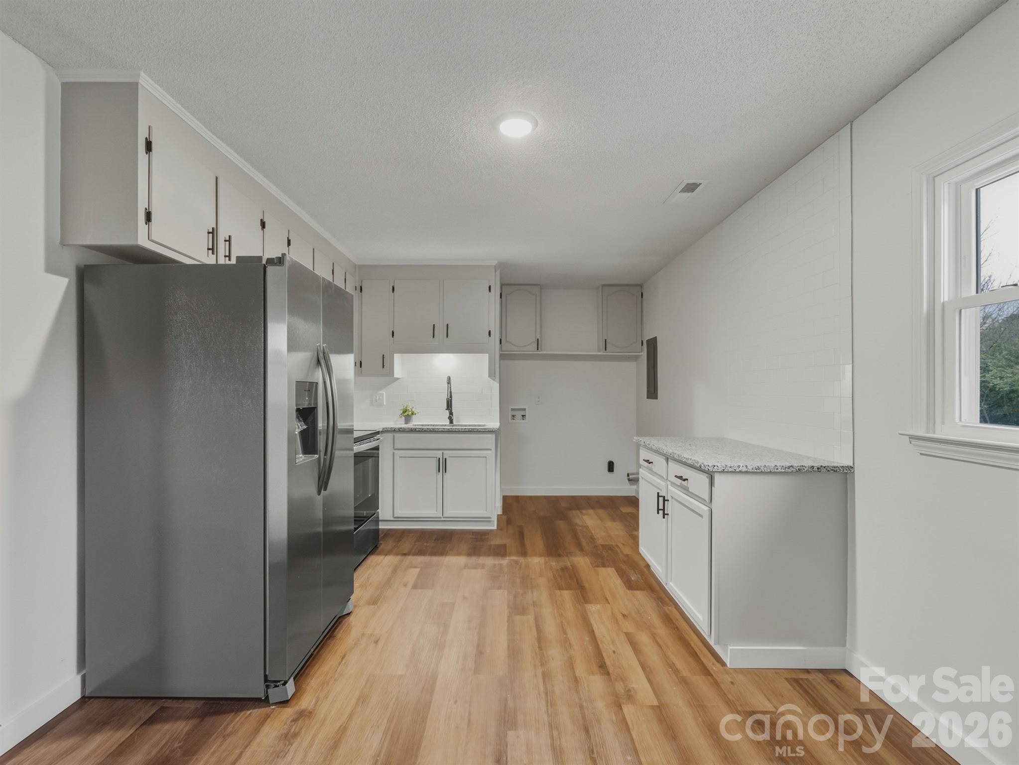 307 Jones Street Monroe, NC 28110 - Photo 11 of 22 a kitchen with a refrigerator a sink and dishwasher