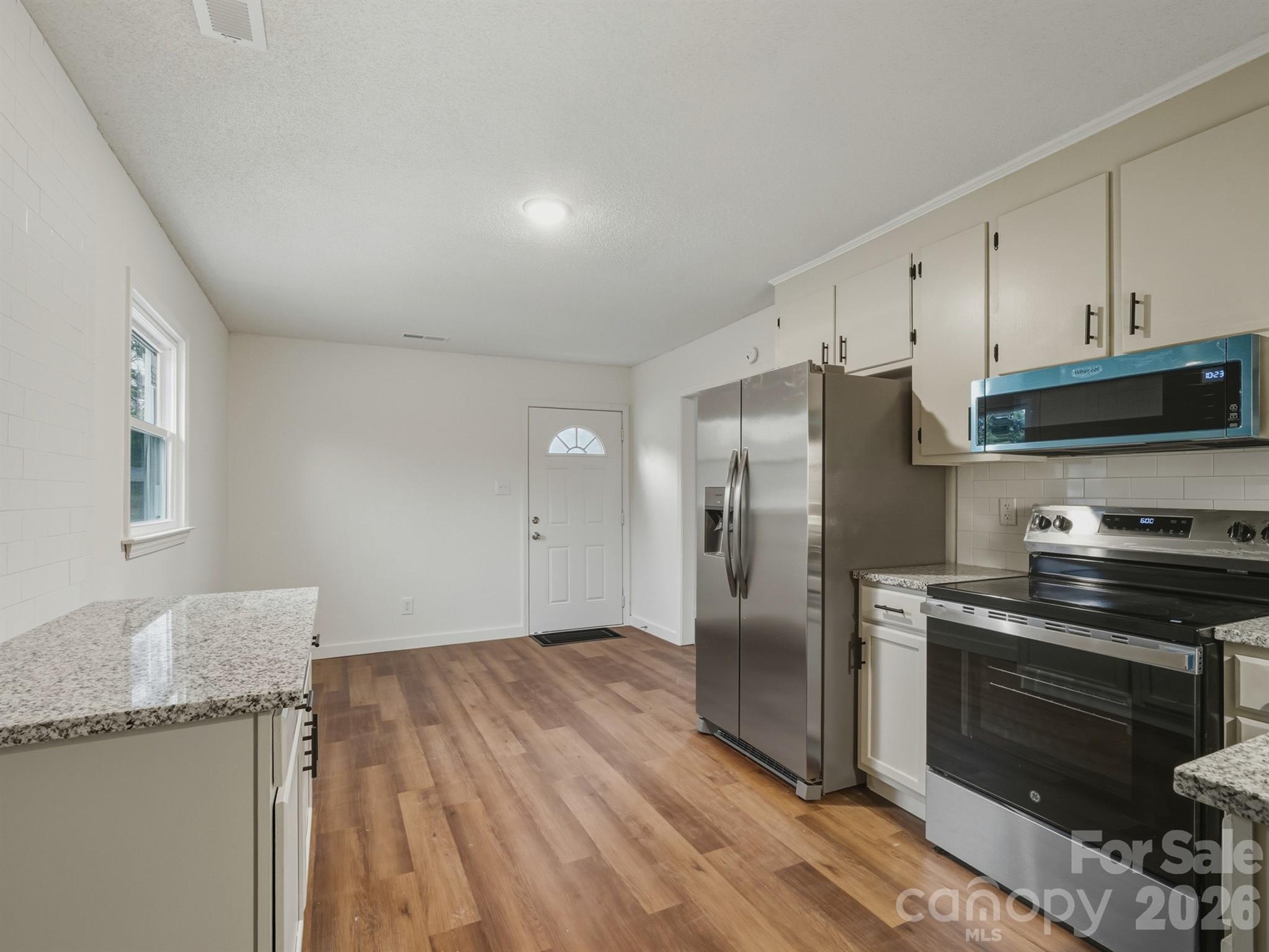 307 Jones Street Monroe, NC 28110 - Photo 12 of 22 a kitchen with stainless steel appliances granite countertop a refrigerator and a stove top oven