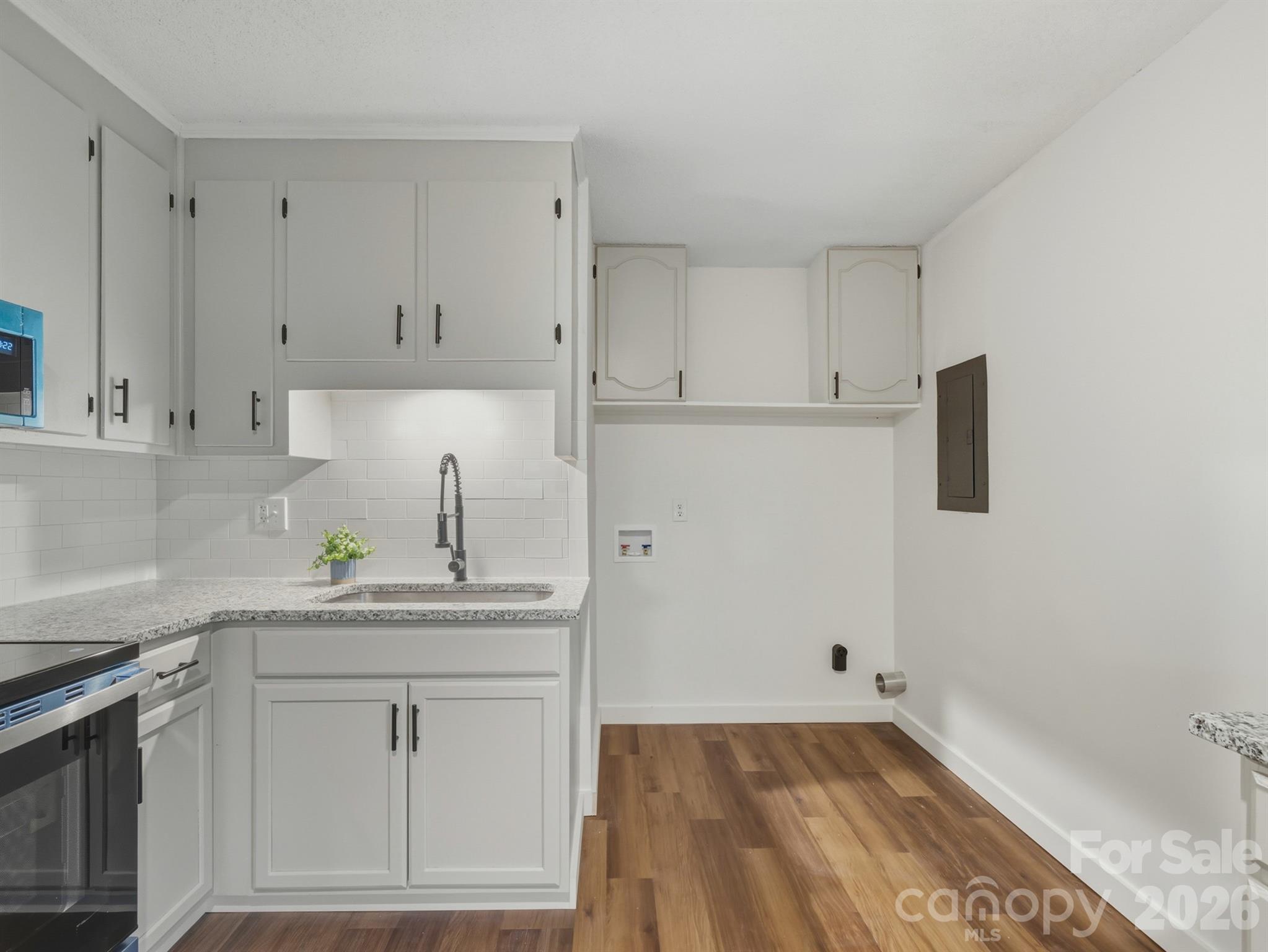 307 Jones Street Monroe, NC 28110 - Photo 13 of 22 a kitchen with white cabinets and sink