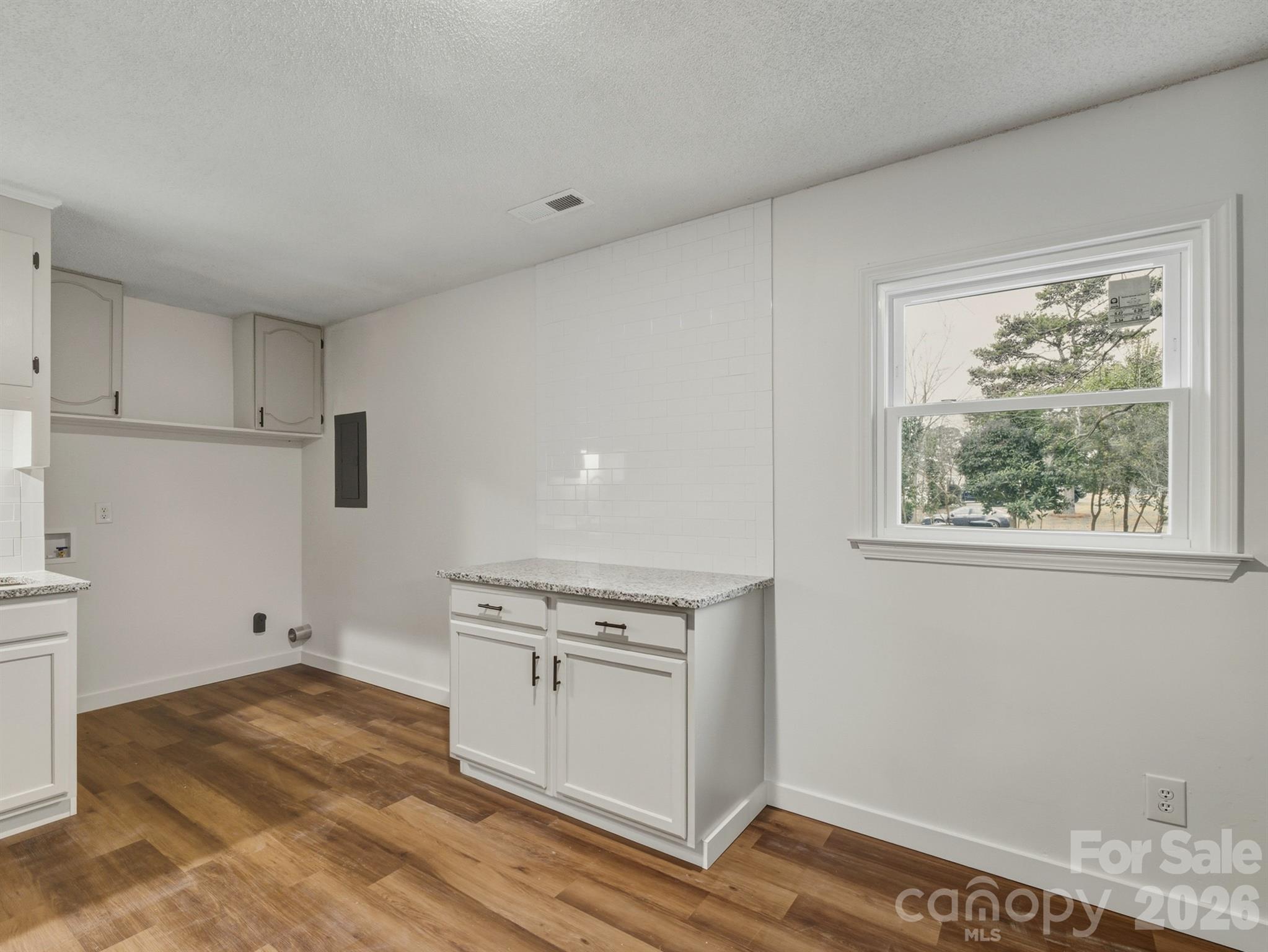 307 Jones Street Monroe, NC 28110 - Photo 14 of 22 a view of a kitchen with wooden floor and cabinets