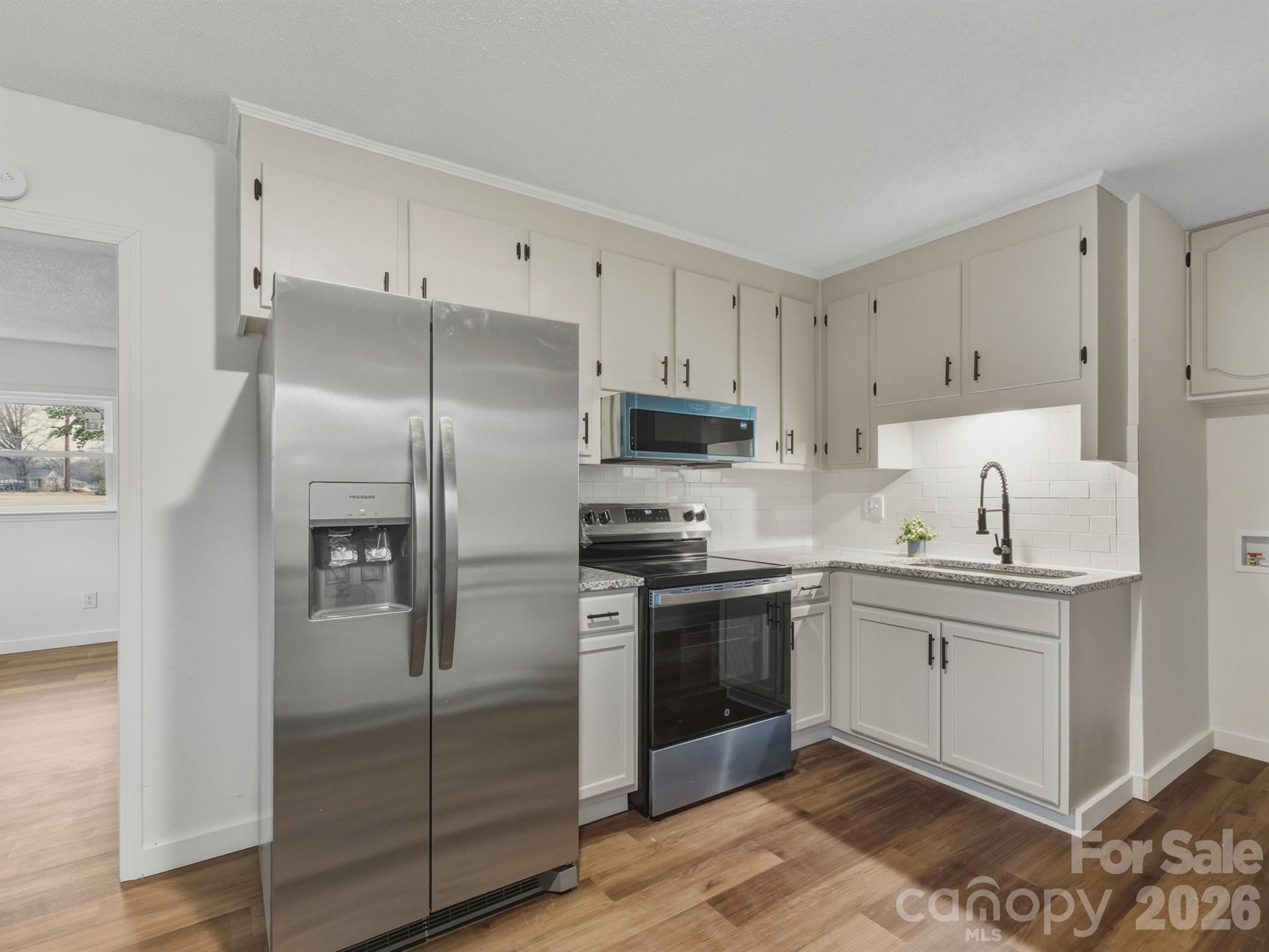 307 Jones Street Monroe, NC 28110 - Photo 15 of 22 a kitchen with cabinets stainless steel appliances and a counter space