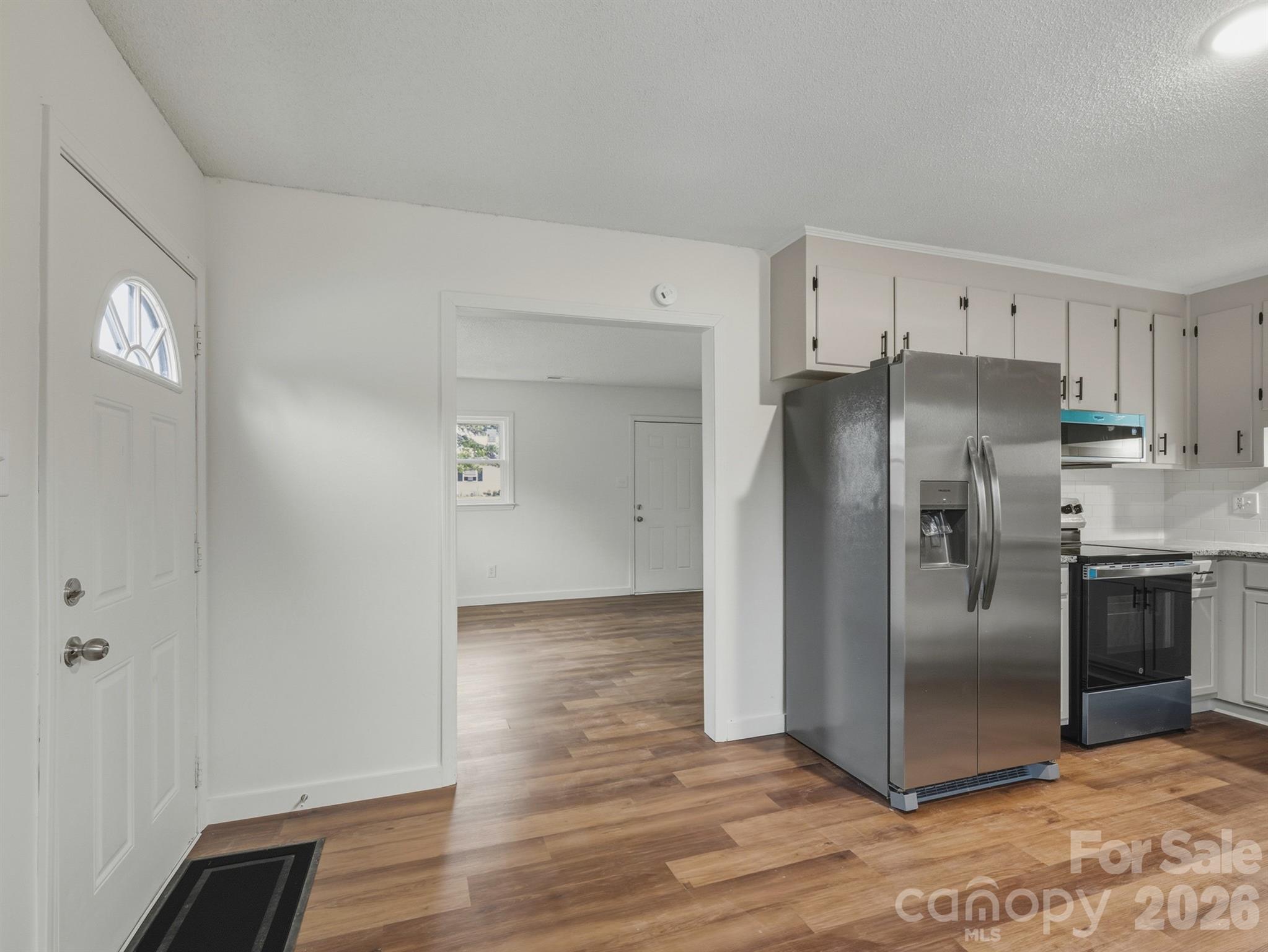307 Jones Street Monroe, NC 28110 - Photo 16 of 22 a kitchen with granite countertop a refrigerator and a stove top oven