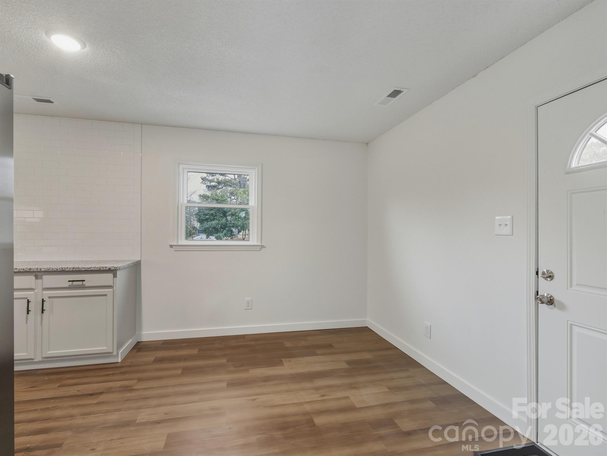 307 Jones Street Monroe, NC 28110 - Photo 17 of 22 wooden floor in an empty room