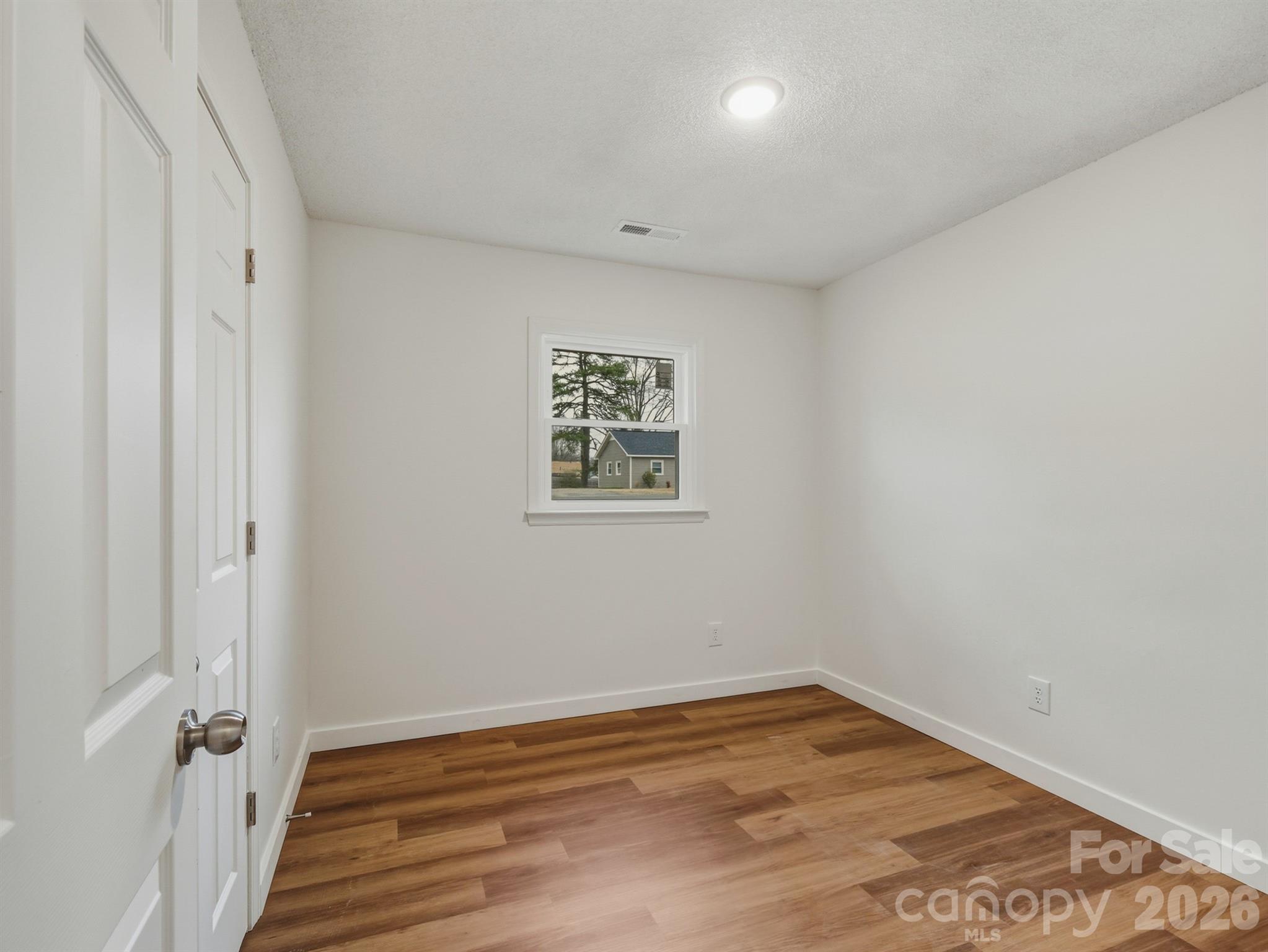307 Jones Street Monroe, NC 28110 - Photo 19 of 22 a view of a room with wooden floor and white walls