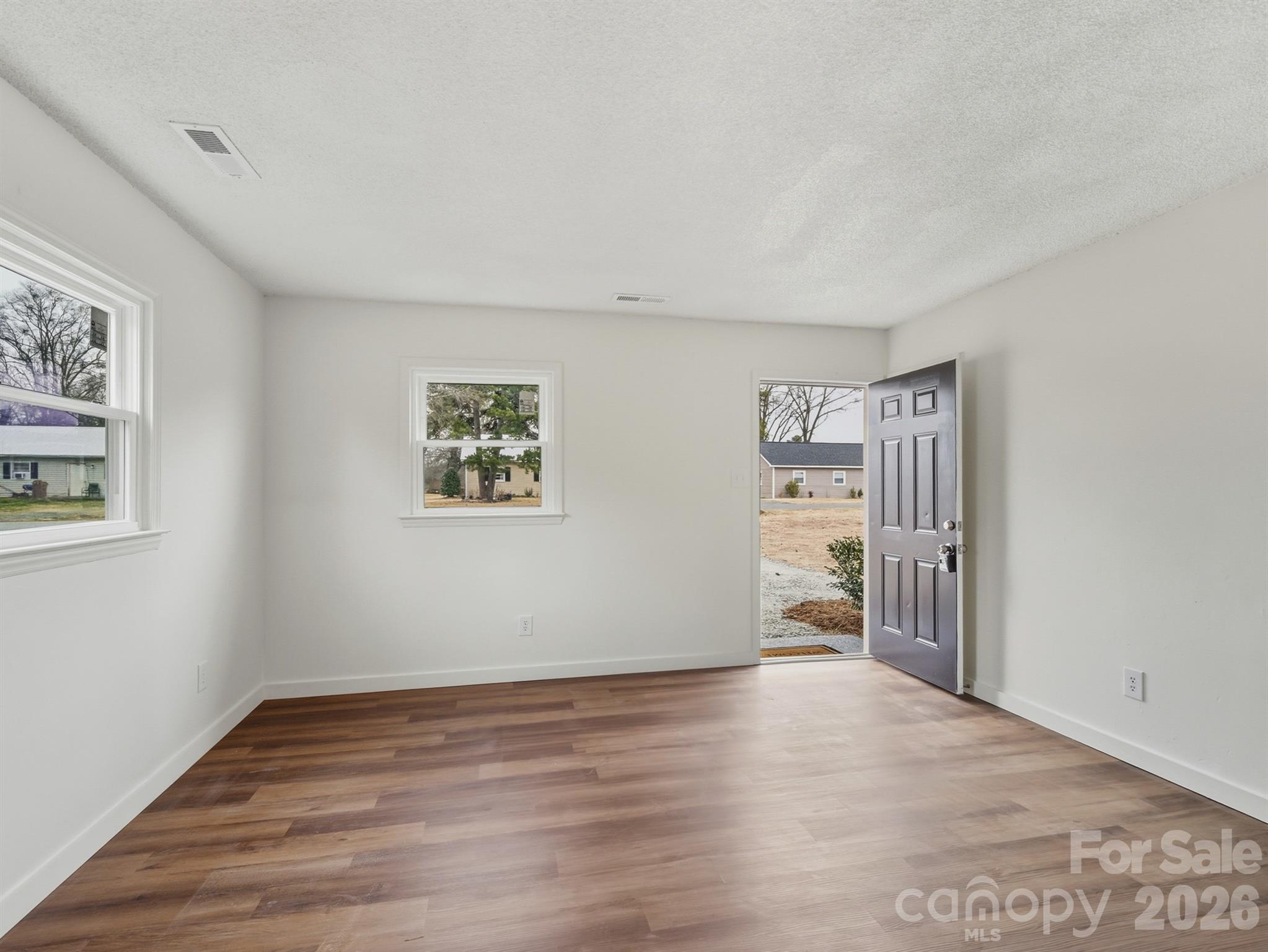 307 Jones Street Monroe, NC 28110 - Photo 6 of 22 a view of empty room with wooden floor