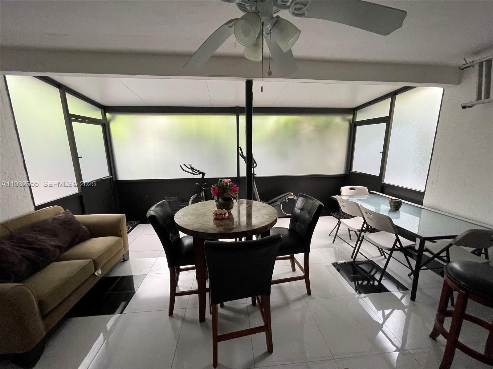 8951 Southwest 16th Street Boca Raton, FL 33433 - Photo 3 of 7 a living room with furniture and a large window