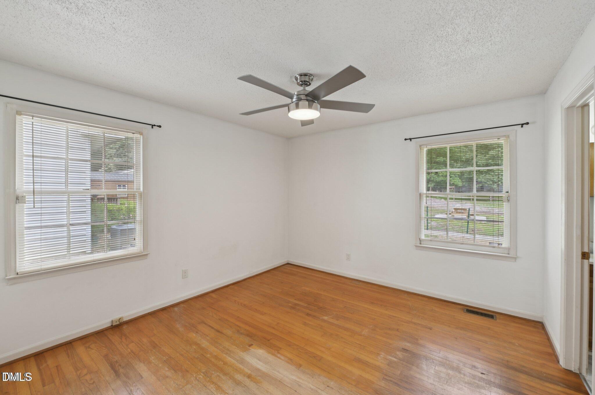 555 Dacian Road Raleigh, NC 27610 - Photo 11 of 16 an empty room with a window and a fan