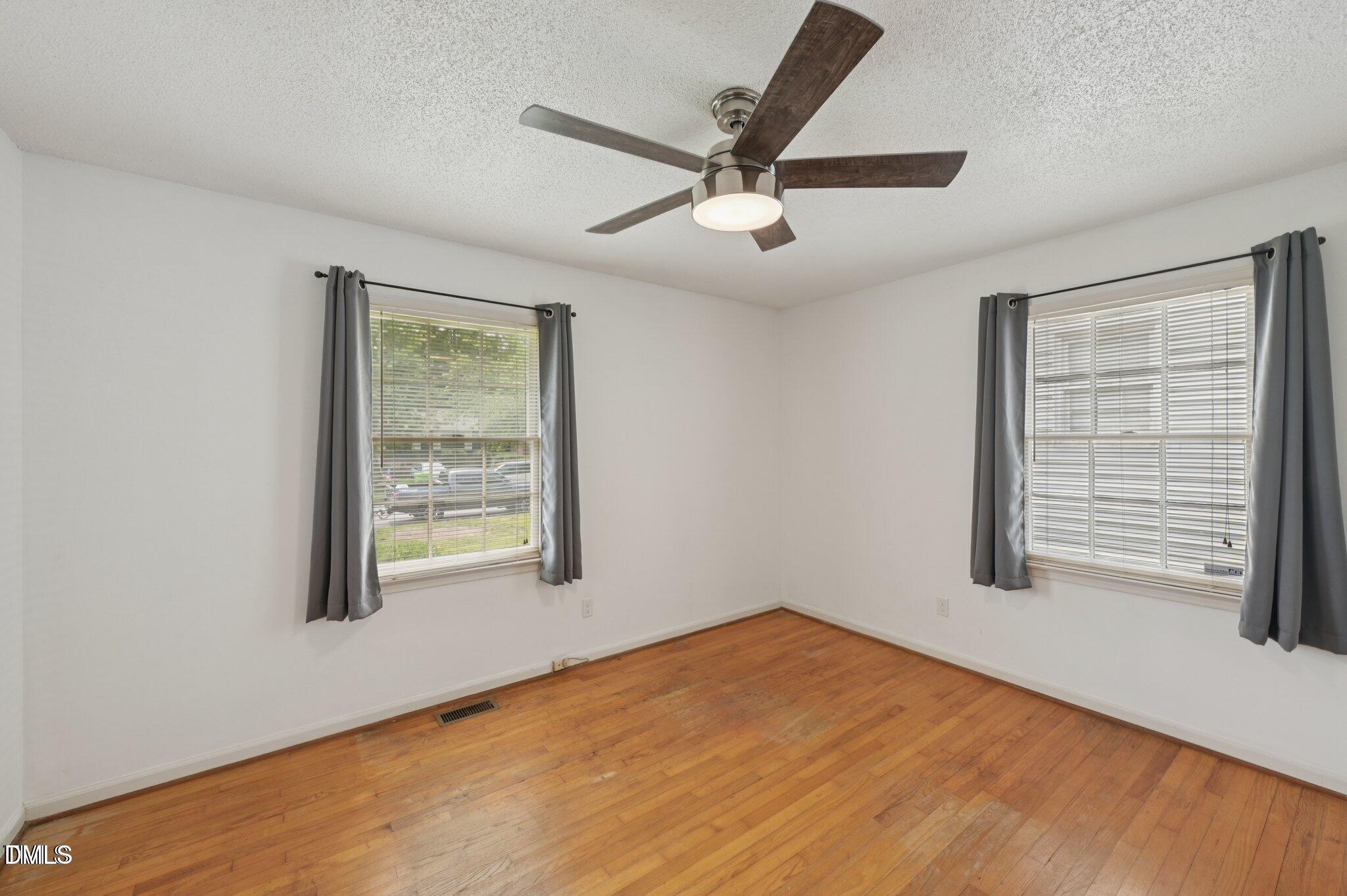 555 Dacian Road Raleigh, NC 27610 - Photo 12 of 16 a view of a big room with windows and chandelier fan