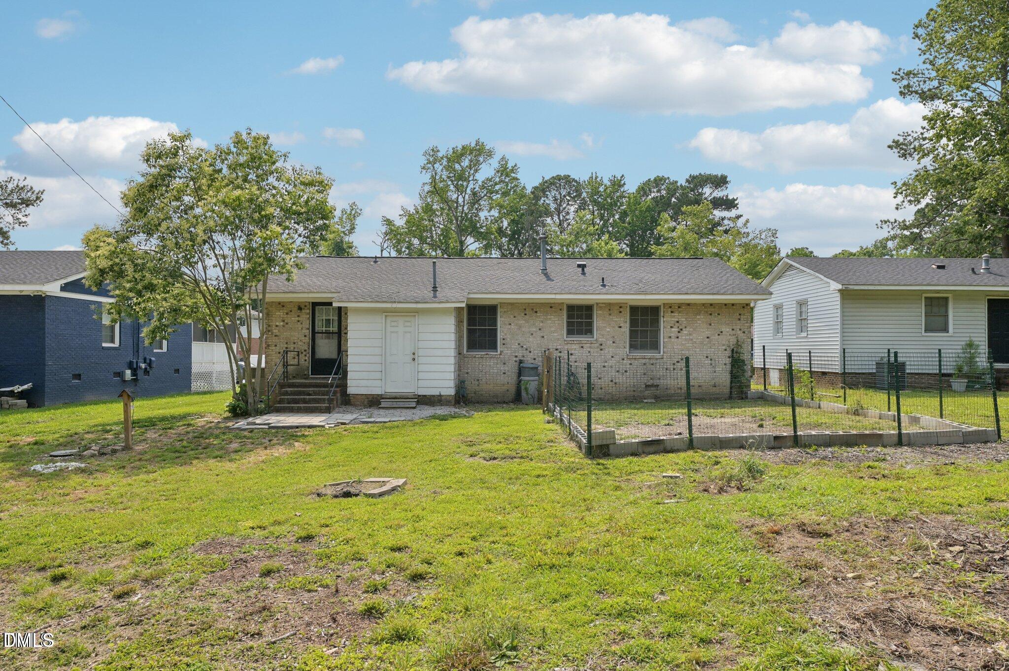 555 Dacian Road Raleigh, NC 27610 - Photo 4 of 16 a backyard of a house with table and chairs