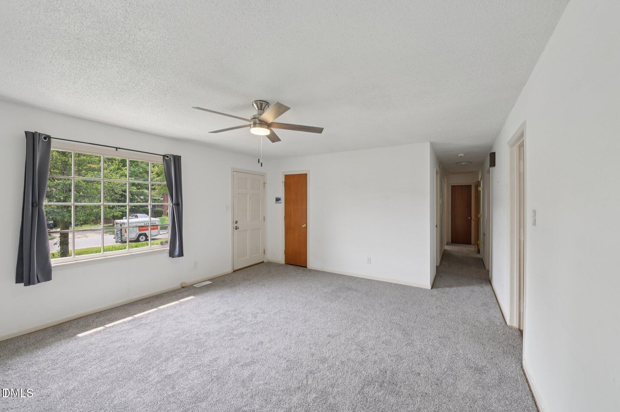 555 Dacian Road Raleigh, NC 27610 - Photo 5 of 16 an empty room with windows and closet