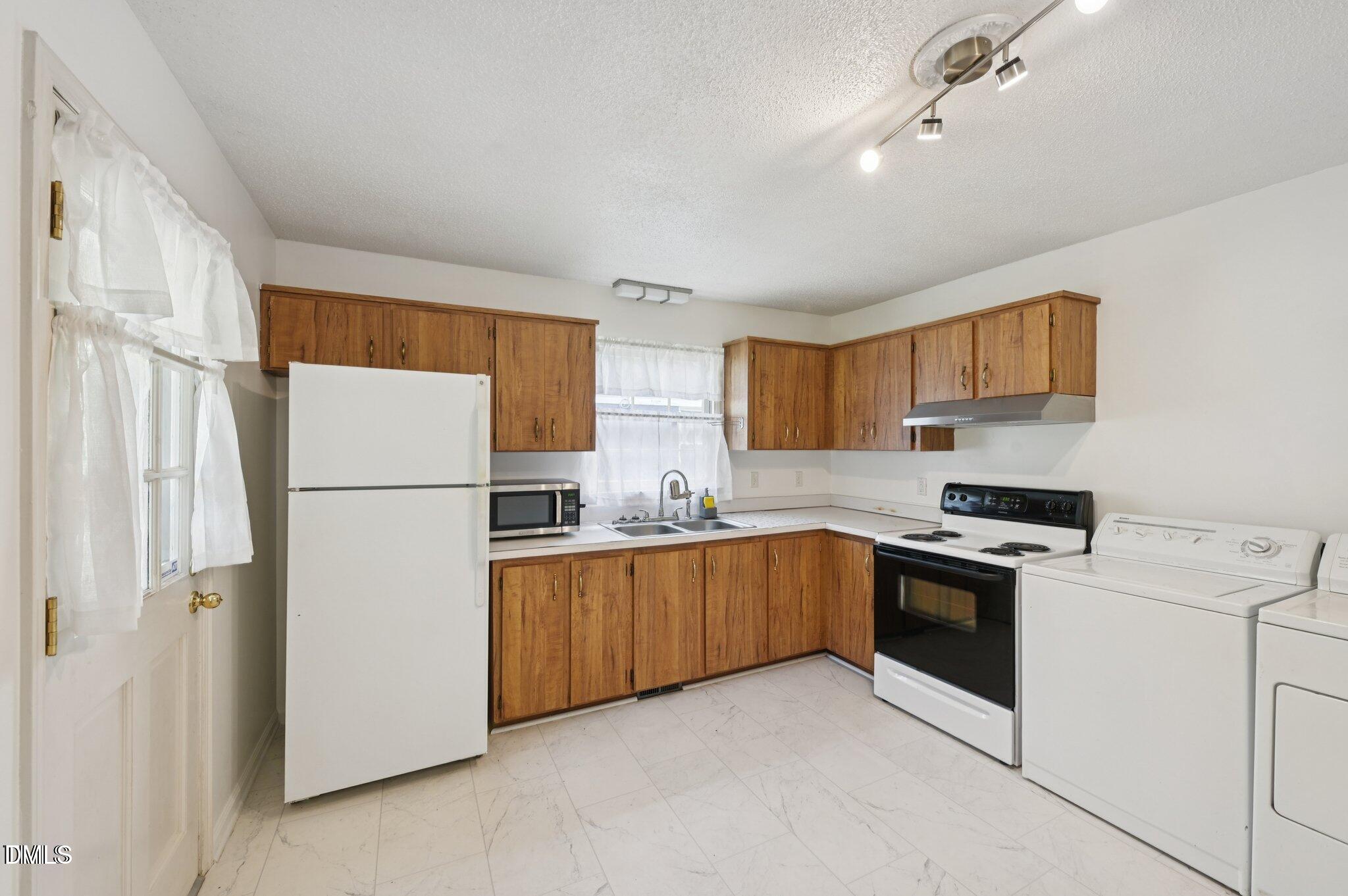 555 Dacian Road Raleigh, NC 27610 - Photo 8 of 16 a kitchen with cabinets and stainless steel appliances