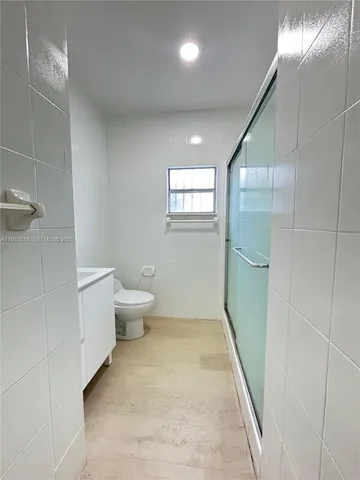 a bathroom with a toilet and a shower