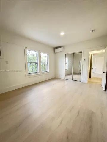 an empty room with a empty space and windows