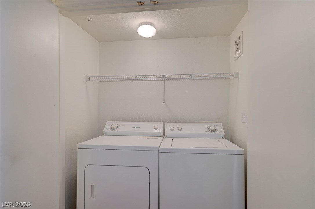 555 East Silverado Ranch Boulevard, Unit 2124 Las Vegas, NV 89183 - Photo 23 of 47 A dedicated laundry space provides optimal functionality with a conveniently placed wire shelf.