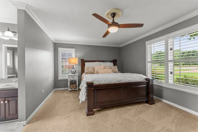 a bed sitting in a room next to a window