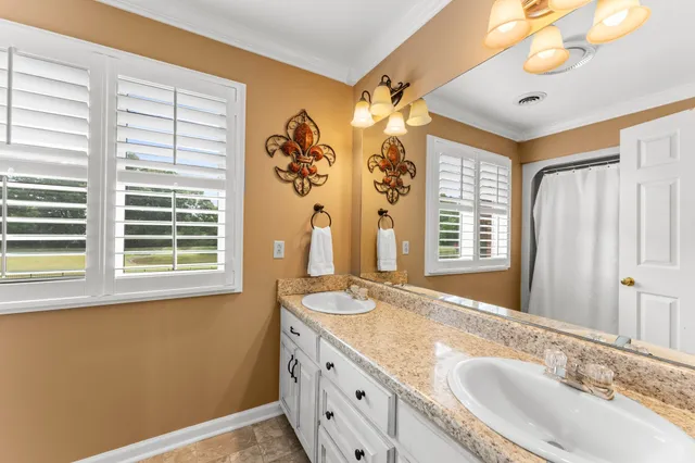a bathroom with a granite countertop sink and a large mirror