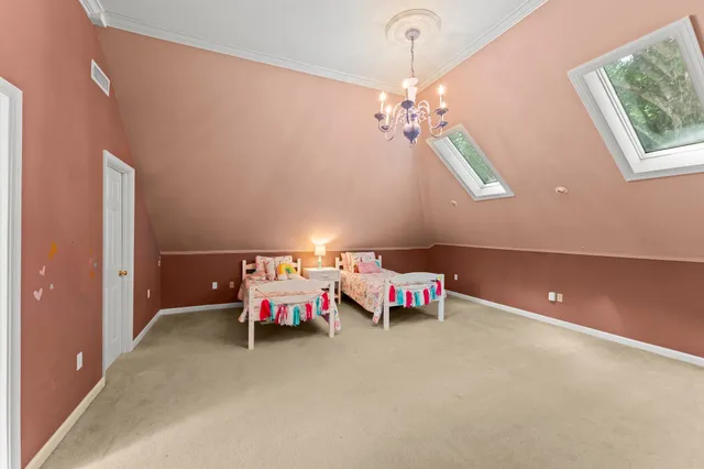 a bedroom with furniture and a chandelier