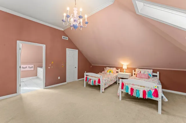 a bedroom with furniture and a chandelier fan