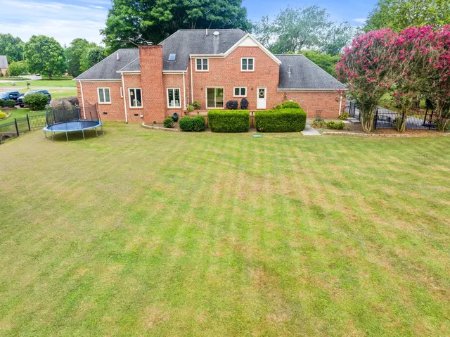 a view of a house with a yard and sitting area