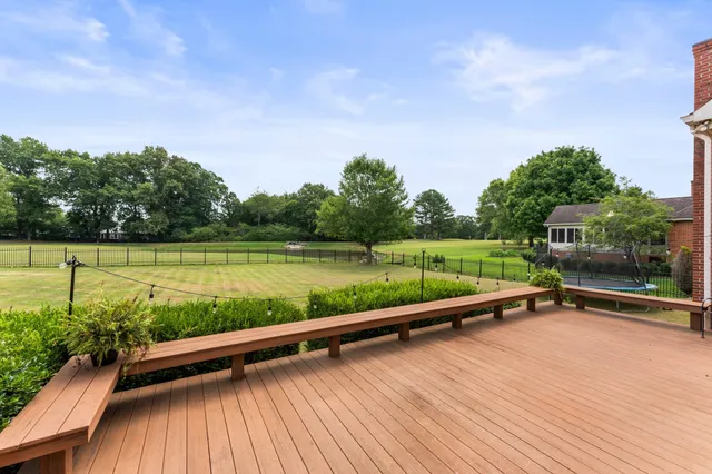 a view of a yard with wooden floor and fence
