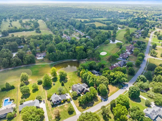 an aerial view of lake residential houses with outdoor space and swimming pool