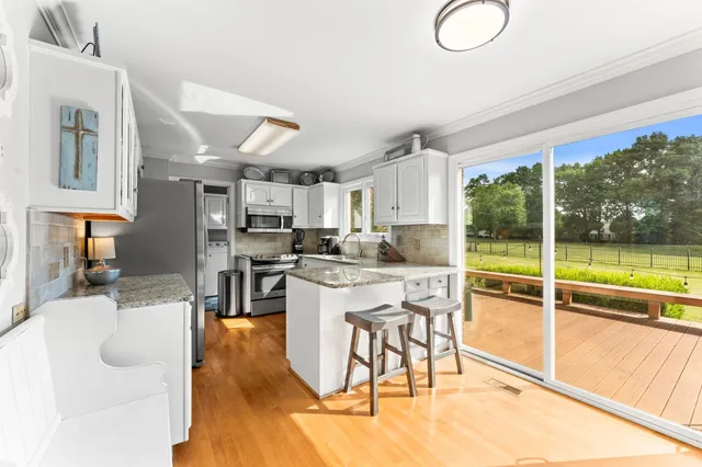 a kitchen with stainless steel appliances granite countertop a stove and a refrigerator