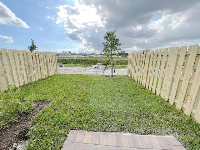 a view of a garden with a building in the background