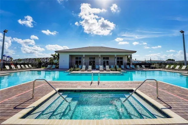 a view of a swimming pool with a table and chairs