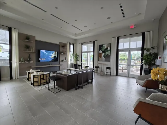 a kitchen with a dining table chairs sink and white cabinets