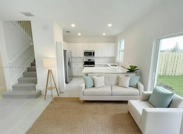 a living room with furniture and a large window