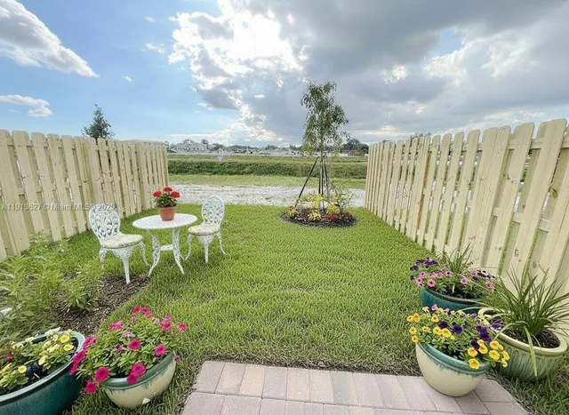 a garden with a table and a chairs