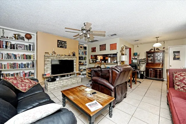 a living room with fireplace furniture and a flat screen tv