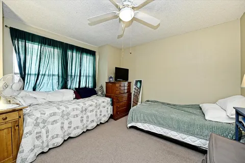 a bathroom with a double vanity sink toilet and a mirror