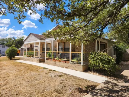 a front view of a house with a garden view
