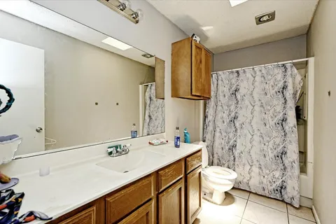 a living room with furniture a rug and a flat screen tv