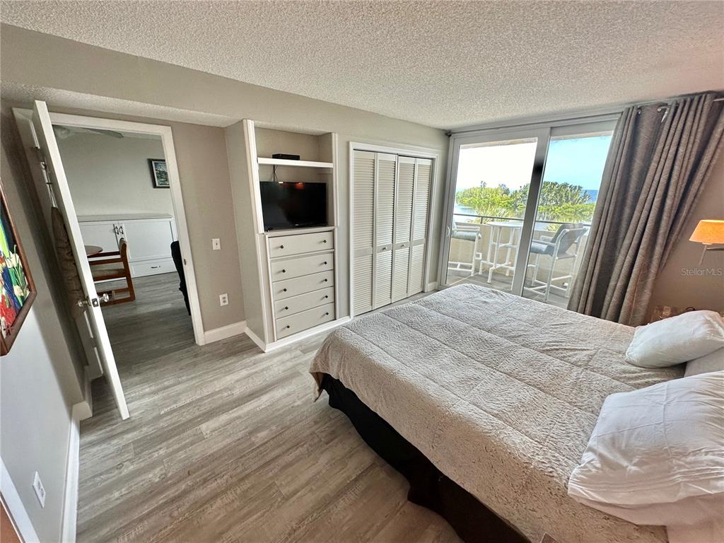 6009 Sea Ranch Drive, Unit 314 Hudson, FL 34667 - Photo 11 of 66 a bedroom with a bed and a large window