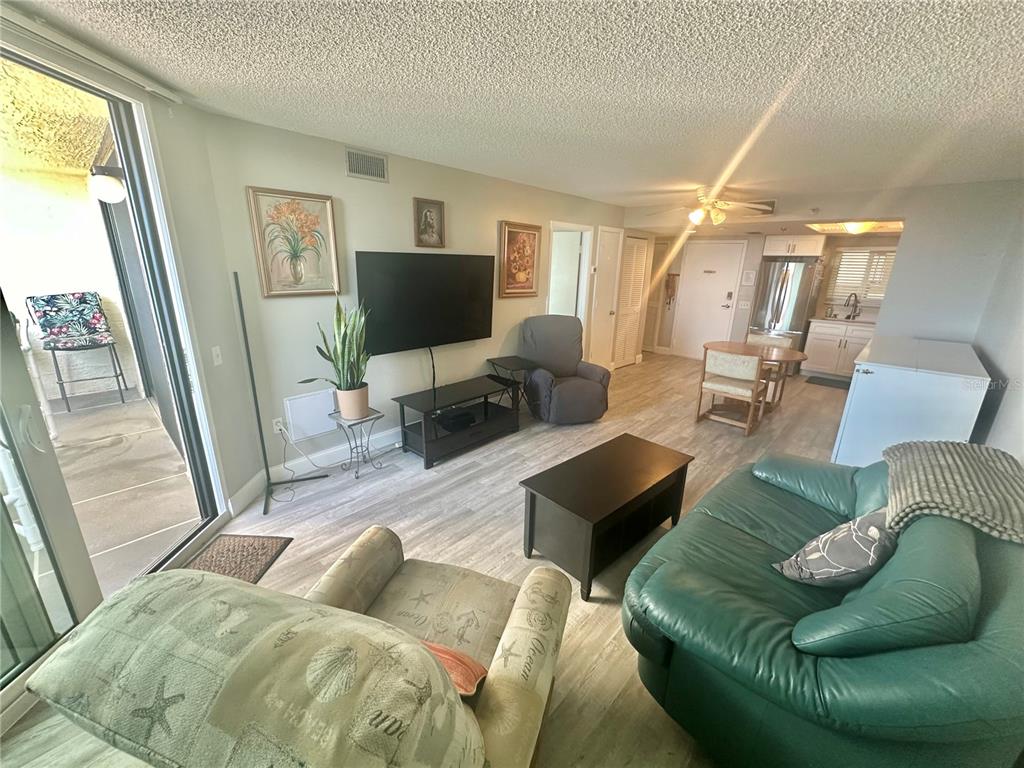 6009 Sea Ranch Drive, Unit 314 Hudson, FL 34667 - Photo 9 of 66 a living room with furniture and a flat screen tv