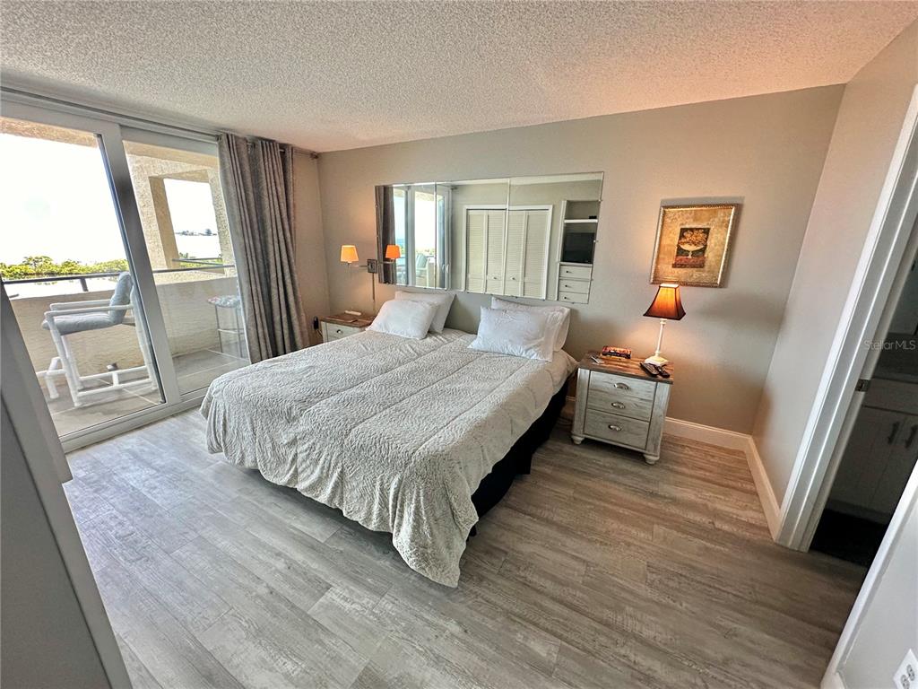 6009 Sea Ranch Drive, Unit 314 Hudson, FL 34667 - Photo 10 of 66 a bedroom with a bed a mirror and a window