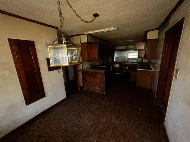 a kitchen with stainless steel appliances granite countertop a refrigerator a stove and a sink