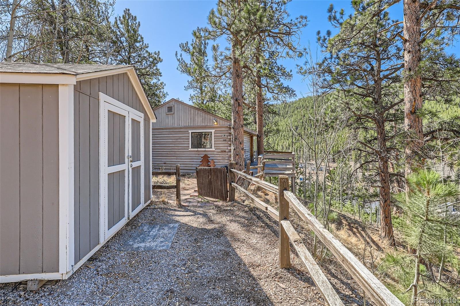 398 Gross Road Bailey, CO 80421 - Photo 2 of 28 a view of a house with backyard and sitting area