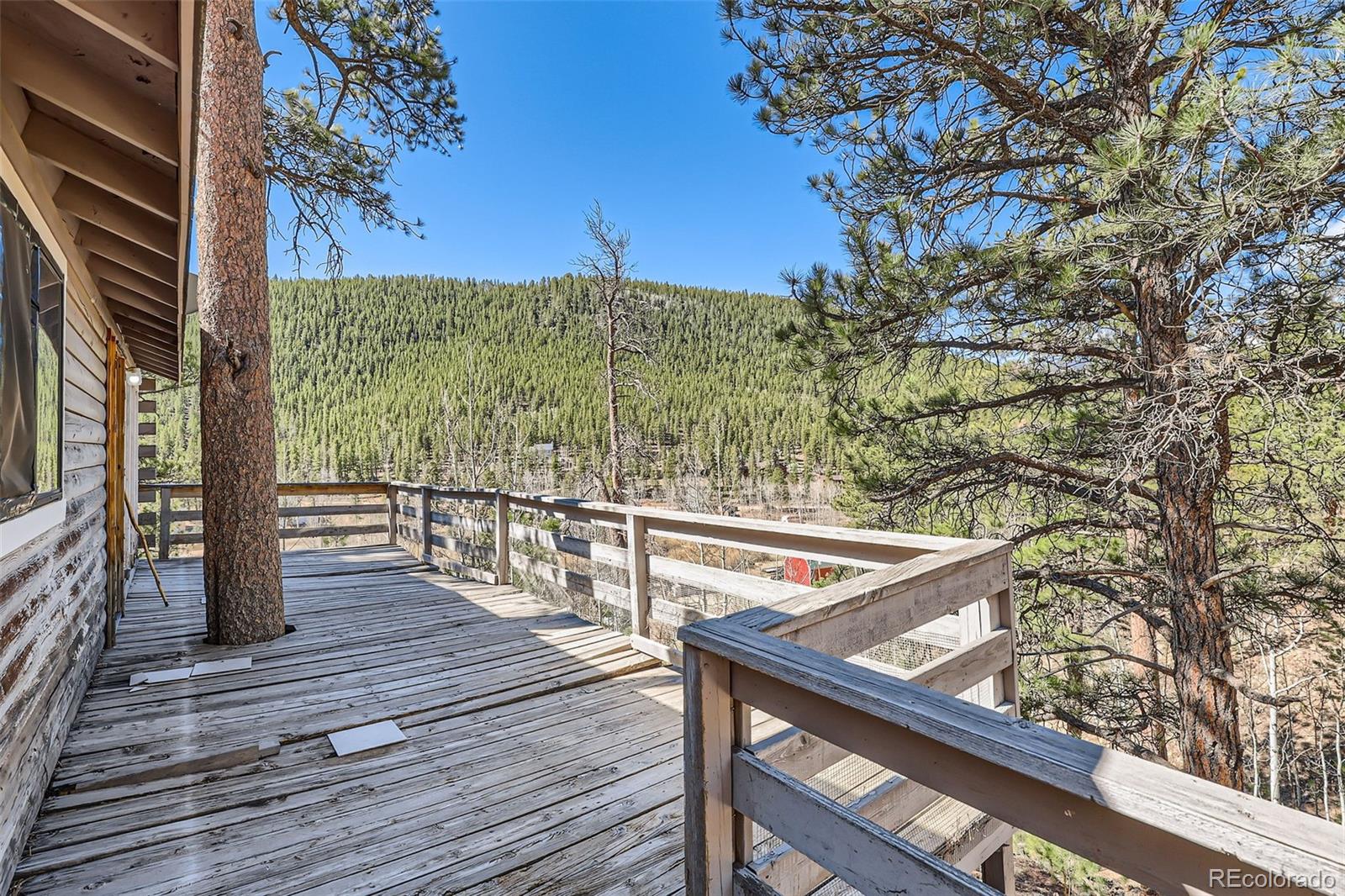 398 Gross Road Bailey, CO 80421 - Photo 24 of 28 a view of balcony with wooden floor and fence