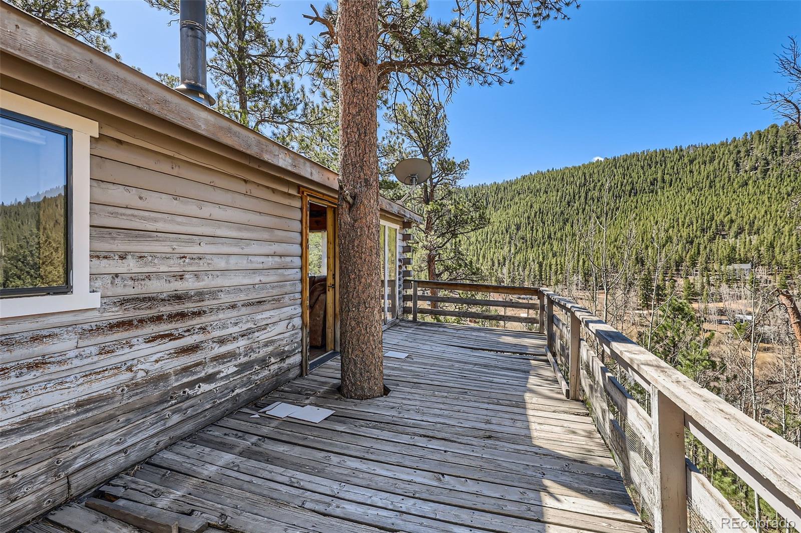 398 Gross Road Bailey, CO 80421 - Photo 25 of 28 a view of a balcony with wooden floor and fence