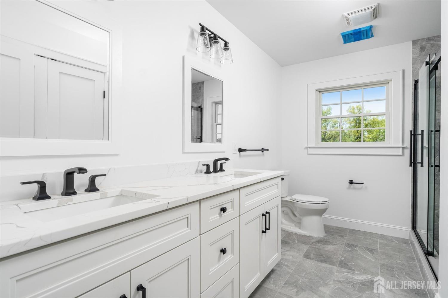 440 Ellisdale Road Chesterfield, NJ 08515 - Photo 22 of 42 a bathroom with a toilet sink and mirror