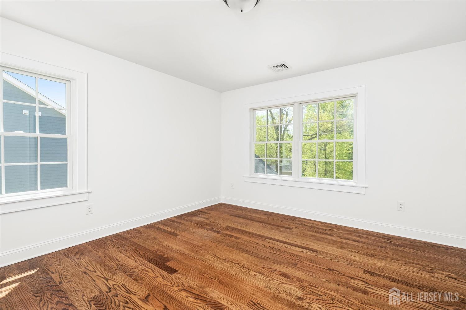 440 Ellisdale Road Chesterfield, NJ 08515 - Photo 25 of 42 an empty room with wooden floor and windows