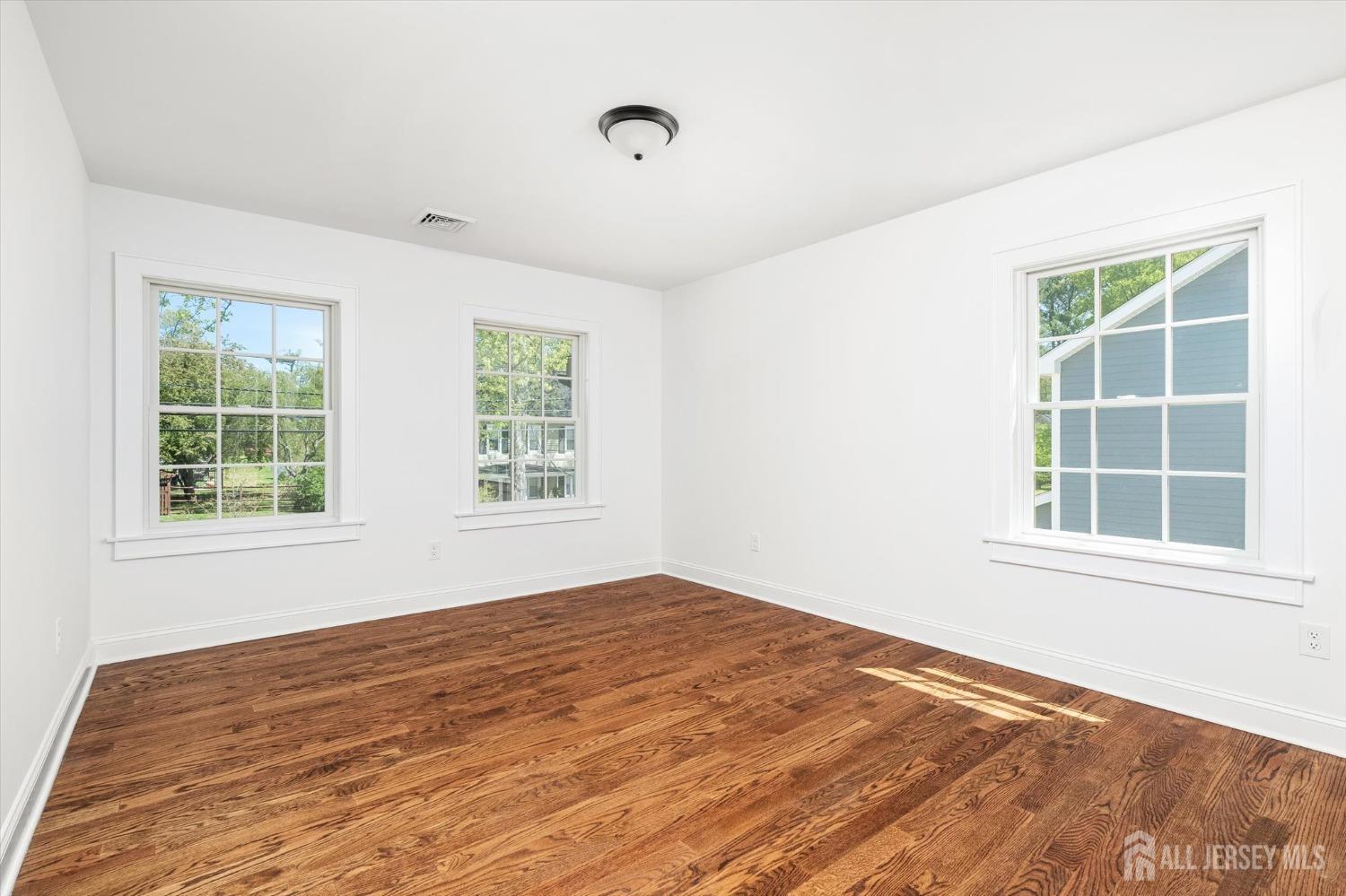 440 Ellisdale Road Chesterfield, NJ 08515 - Photo 27 of 42 an empty room with wooden floor and windows